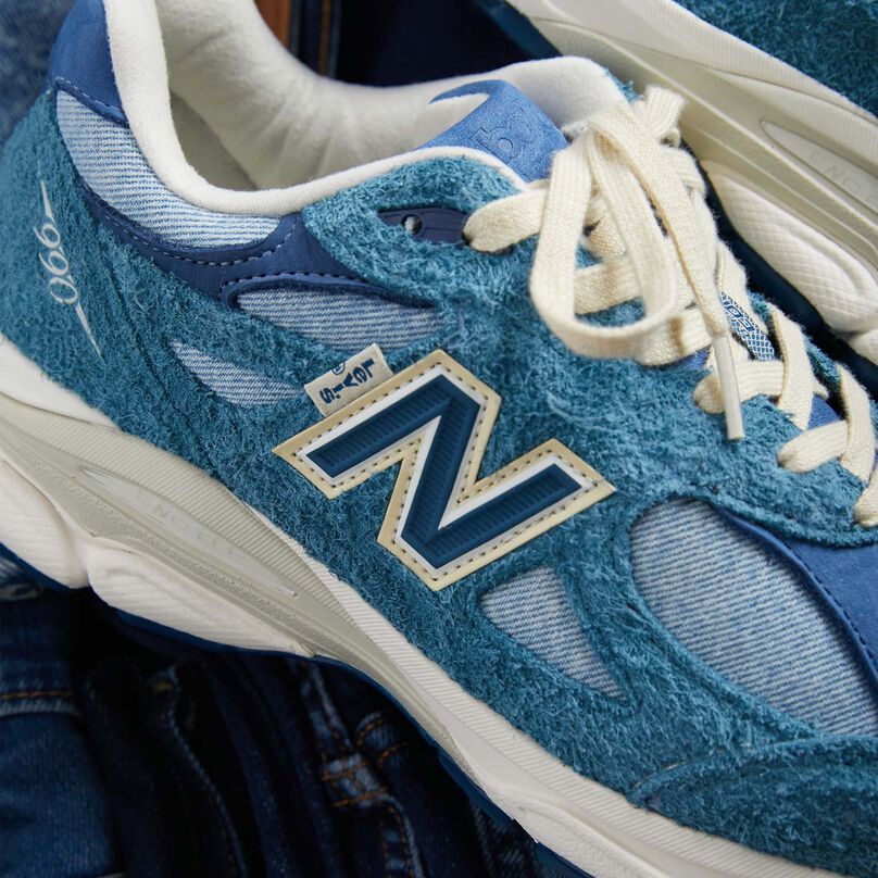 Close up image of 990v3 shoe in blue detailing hairy suede texture