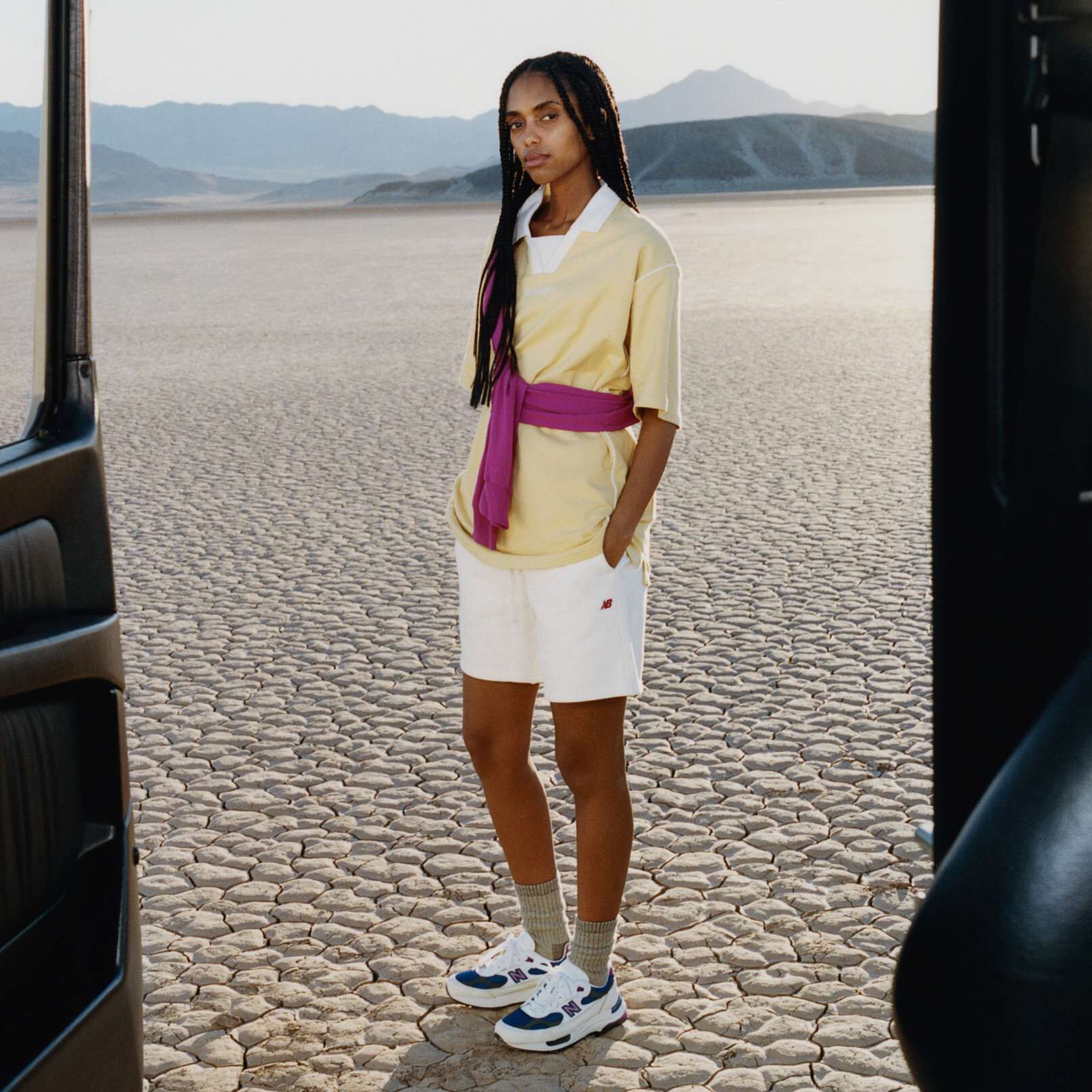 A woman standing in a desert environment wearing New Balance