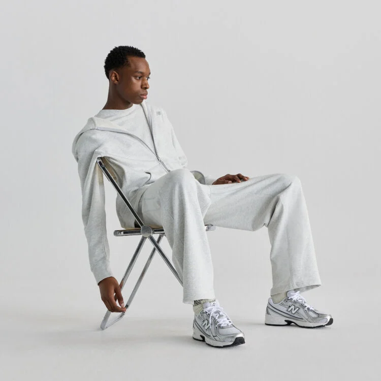 Man sitting on chair wearing New Balance